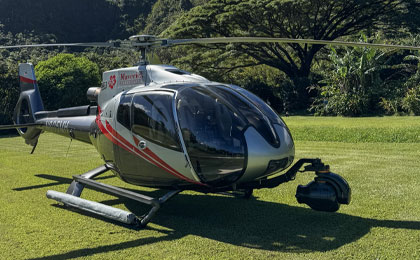 Maverick  helicopter on the ground in Hawaii, equipped with an externally mounted camera system for helicopter filming.