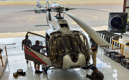 Maverick Helicopter aerial photography crew preparing the aircraft for doors-off photo flight in California.