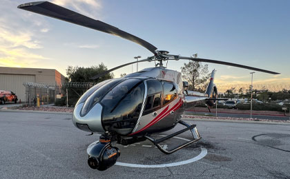 Maverick helicopter on the ground in Las Vegas, equipped with a nose-mounted SHOTOVER F1 camera system for aerial movie production.