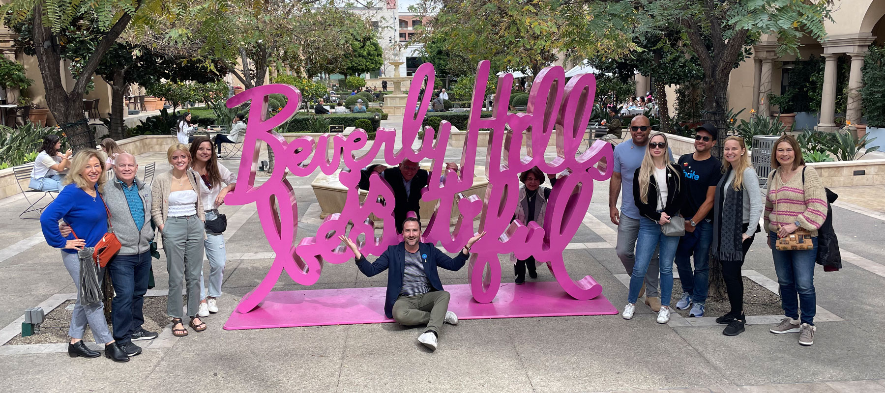 Guests at the Beverly Hills sign on Rodeo Drive during a private food experience