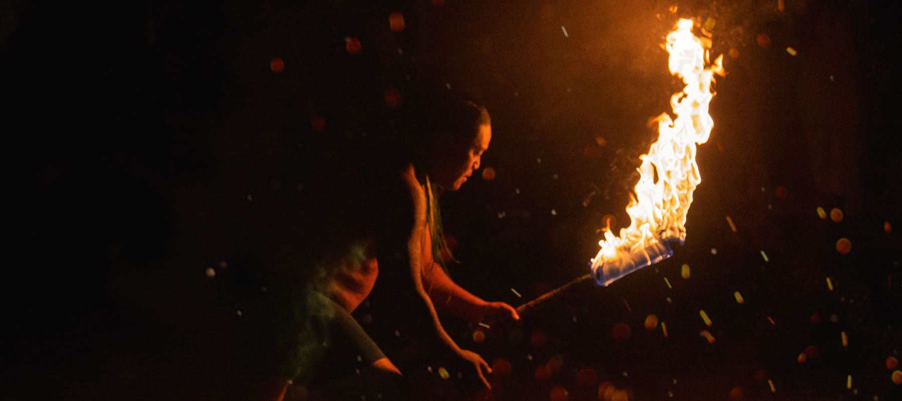Polynesian fire dancer performing at a traditional Maui luau