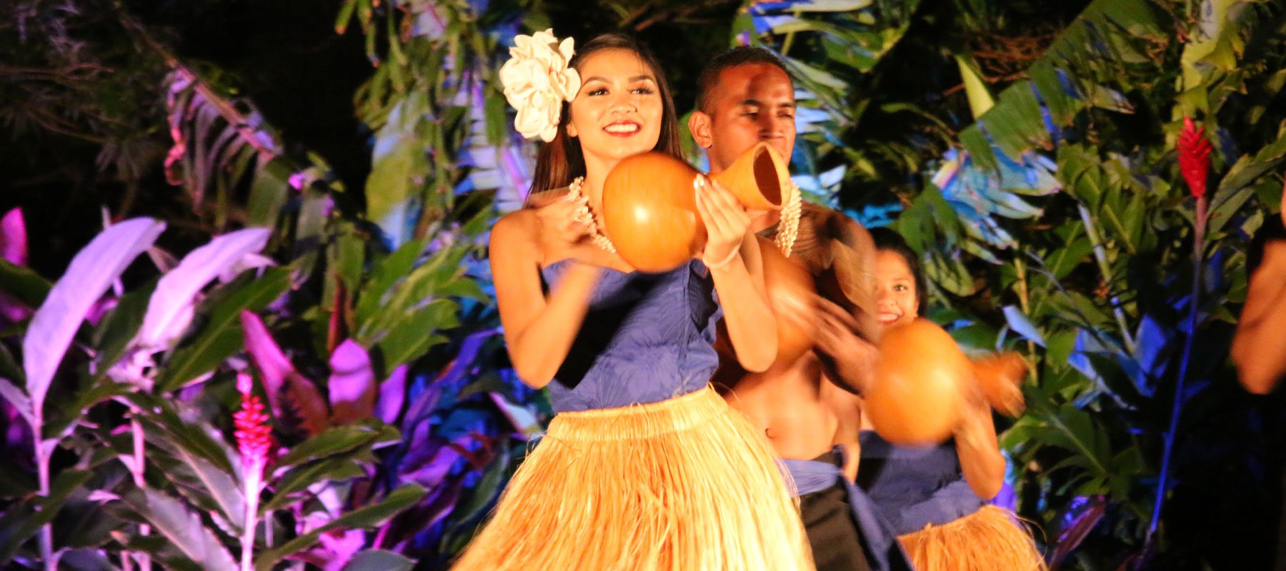 Polynesian hula dancer with traditional ipu gourd drum at the Maui Luau Experience