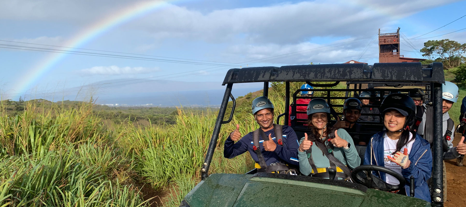 Aerial view of Maui zipline platform overlooking lush green mountains and coastline