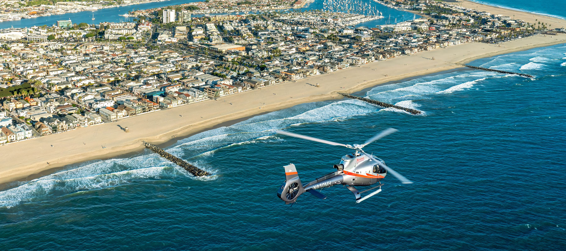 Maverick Helicopters flight along the Huntington Beach shoreline
