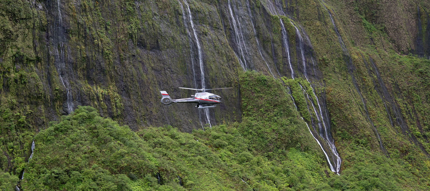Maverick Helicopter flying past the Wall of Tears waterfalls in West Maui