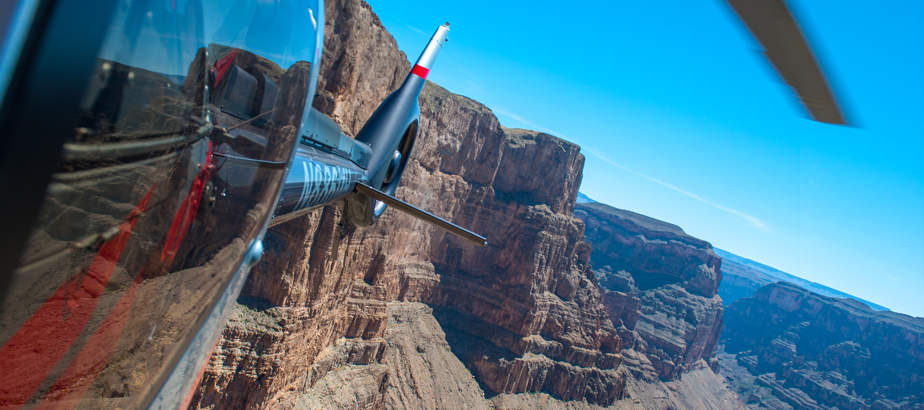 Maverick Helicopter flying through the dramatic rock formations of the Grand Canyon