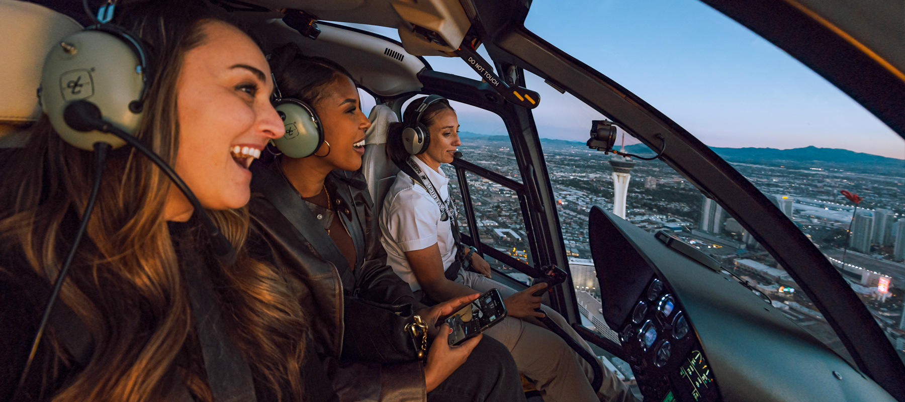 Passengers enjoying the view from inside a helicopter during an evening flight